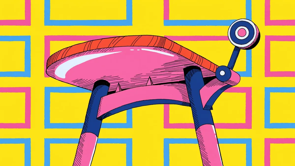 A pink and navy drafting table with a tilted round pink tabletop edged in orange and a small knob and lever on the right, standing on two navy and pink legs against a yellow background patterned with blue and pink rectangle outlines.